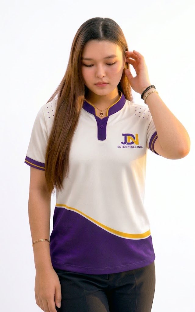 Team member wearing the JDN employee polo: white Chinese collar polo with purple wave, gold trim and embroidered JDN logo